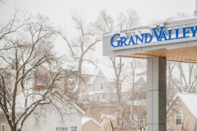  A person walks out of Raleigh J. Finkelstein Hall into a snowy afternoon on Grand Valley State University�s Health Campus earlier this month.