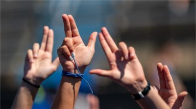 Grand Valley fans hold up the Anchors Up hand sign