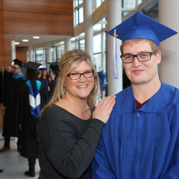Bryce Gould pictured with his mother, Sarah VanOeveren, at the December 10 commencement ceremony. Photo by Rex Larsen.