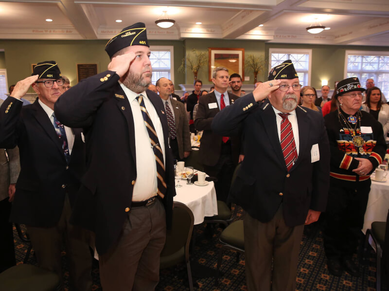 Many veterans standing saluting