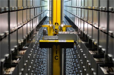 The Dematic ASRS crane retrieves a box of books.