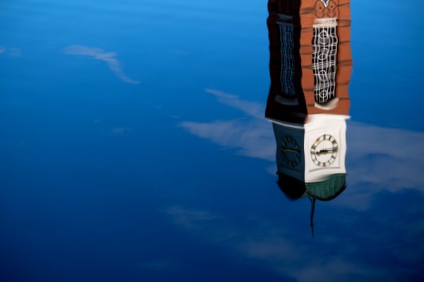  A carillon tower is reflected into a pond. 