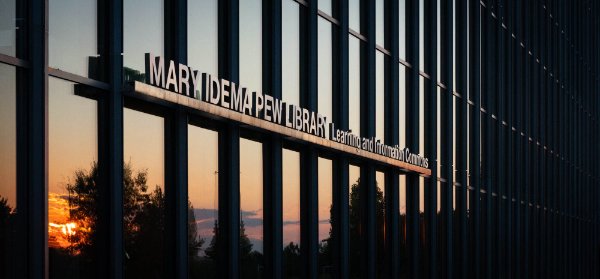  The sunset is reflected in the Mary Idema Pew Library windows. 