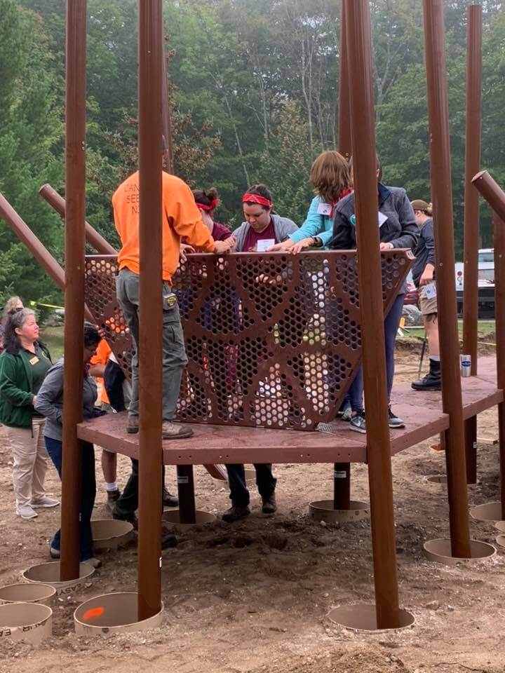 Students and HTM industry professionals install a new playground at the Leelanau State Park.