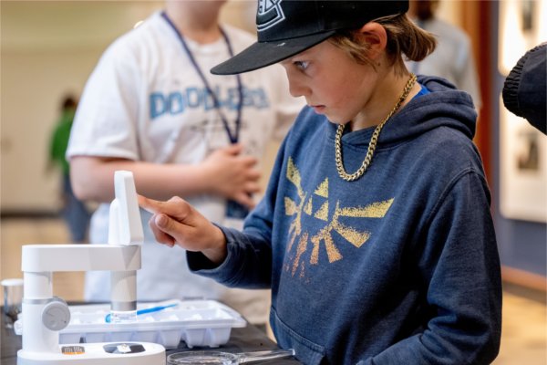 M.J. Edington looks at the Stonefly Project during the Groundswell Stewardship Initiative Student Project Showcase.