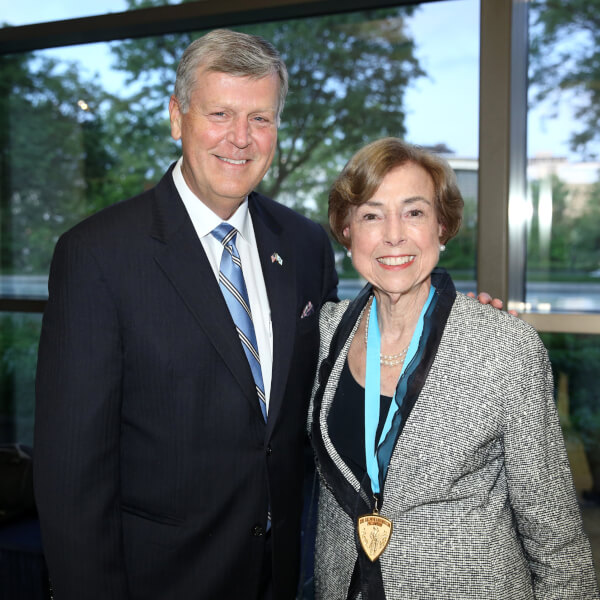 President Thomas J. Haas and Ambassador Carla Hills pose for a photograph in the lobby of the Ford Presidential Museum in Grand Rapids.