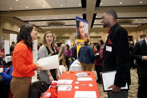 A student talks with employers at the Winter 2012 Career Fair. 