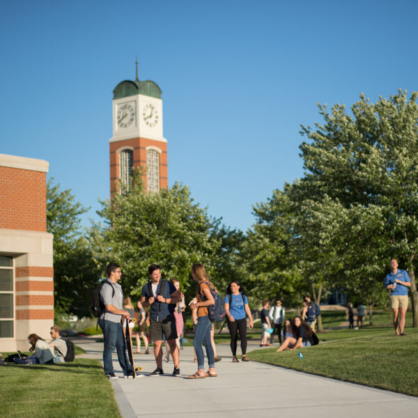 Students on Allendale Campus, carillon tower in background