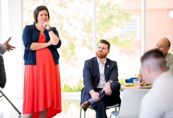 Heather Tsavaris, left, and Student Veterans of America President Jared Lyon, center, listen to a panel during a GVSU Laker Veterans luncheon where a veteran suicide prevention project was discussed.