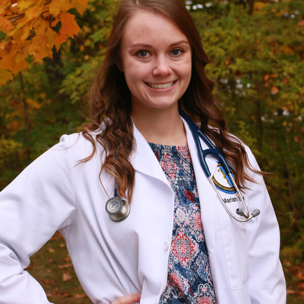 woman wearing a medical white coat outside