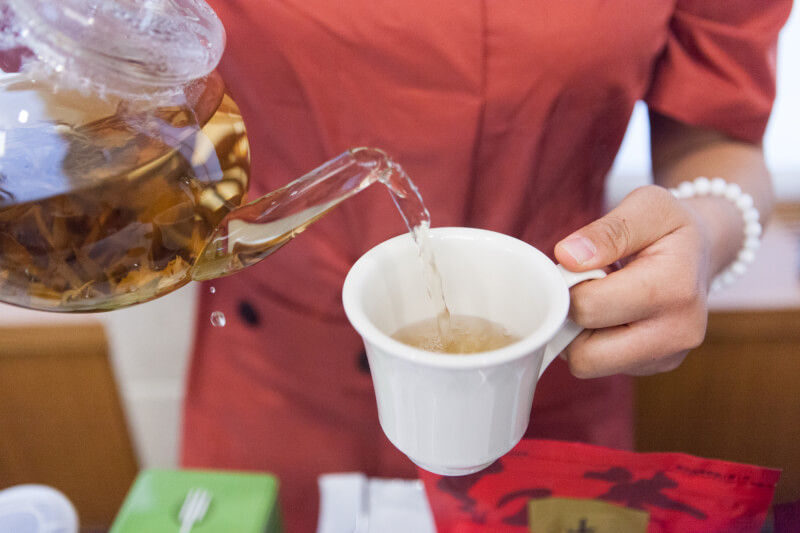 Ruixuan Ran, a senior from China who is majoring in accounting and international business, hosted a tea table for area business leaders who are learning best practices for doing business abroad.