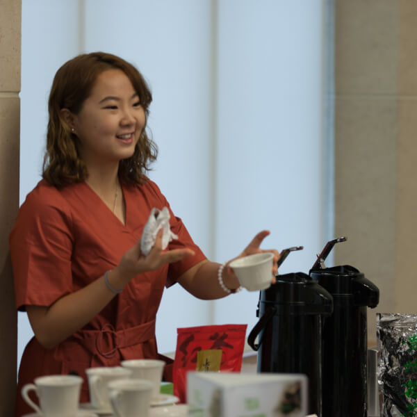 Ruixuan Ran, a senior from China who is majoring in accounting and international business, hosted a tea table for area business leaders who are learning best practices for doing business abroad.