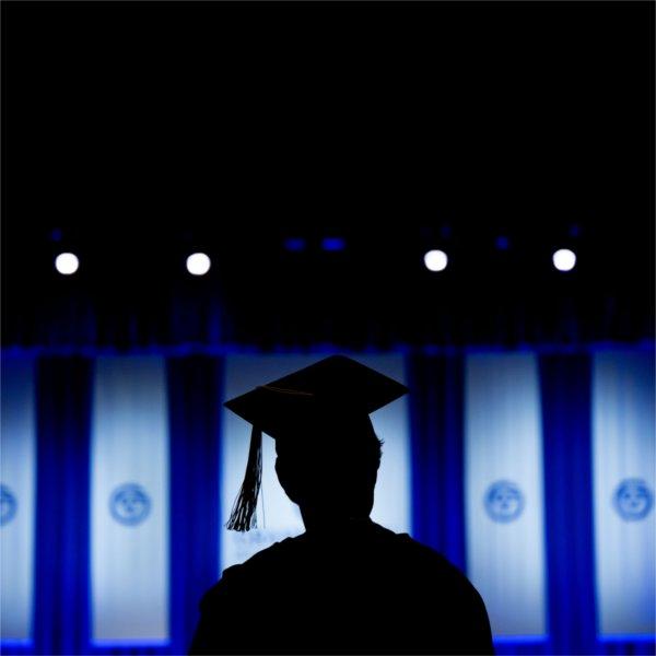 Silhouette of a graduate student wearing a cap