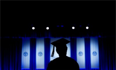 Silhouette of a graduate student wearing a cap