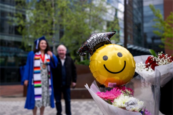 Friends and families greet recent graduates to give them flowers, balloons and stuffed animals after the Saturday afternoon Commencement ceremony at Van Andel May 2. 