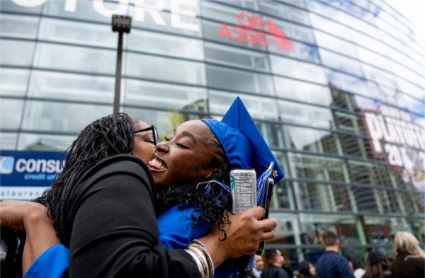 Lakeesha Dorkins, left, hugs her daughter, Destini Dorkins, after she received her degree in Human Resource Management during Saturday morning&#8217;s Commencement ceremony May 2. &#8220;Her faith is her strength,&#8221; her mother said about her daughter. &#8220;She inspires me and we are forever proud.&#8221; 