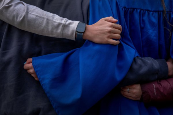 Wrapped in an embrace, a recent graduate poses for a photo during the Saturday morning Commencement ceremony May 2. 