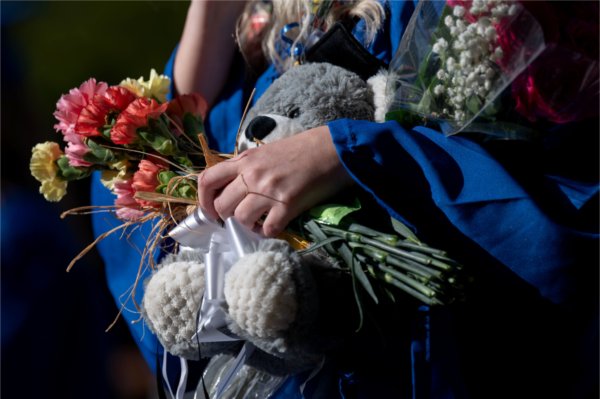 Friends and families greet recent graduates to give them flowers, balloons and stuffed animals after the Saturday afternoon Commencement ceremony at Van Andel May 2. 