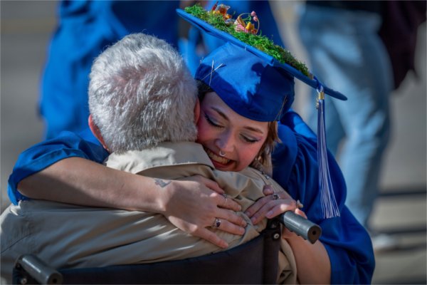Amelia VanWyck hugs their grandmother, Lori Boza, left, after VanWyck received a bachelor of fine arts degree during Saturday afternoon&#8217;s Commencement ceremony at Van Andel Arena May 2.
