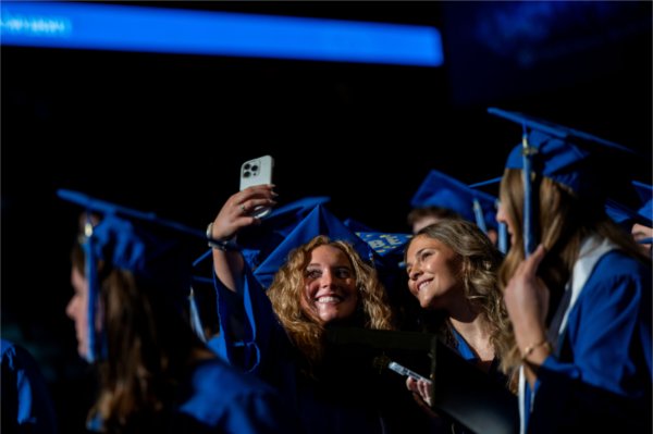 Graduates take a selfie together as they recess out of Saturday morning&#8217;s ceremony. 