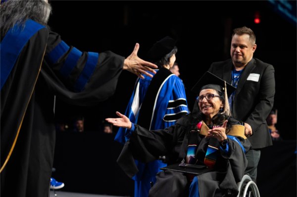 Delia Gale, a graduate of Grand Valley State University's Seidman College of Business, is conferred a Master of Business Administration during the university's morning Commencement on May 2.