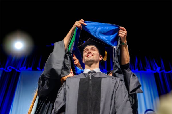 A graduate being hooded