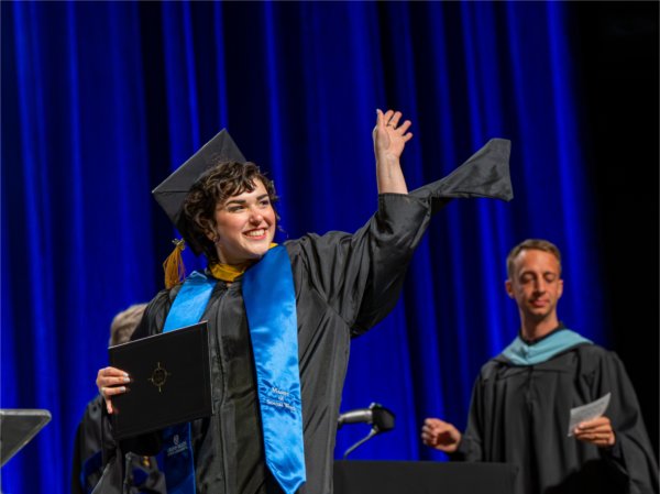 A graduate reacts while walk past the stage after receiving their diploma during the Commencement ceremony at Van Andel Arena on May 1.