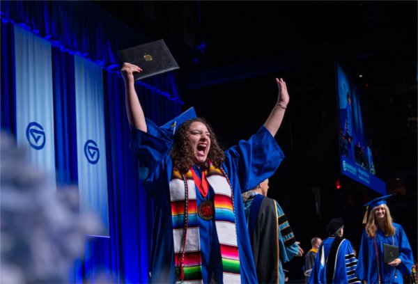 A graduate walks past the stage after receiving their diploma during the afternoon Commencement ceremony at Van Andel Arena on May 2.
