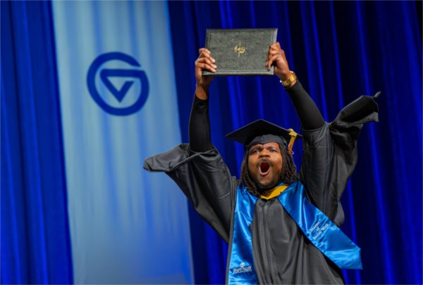 A graduate reacts while walk past the stage after receiving their diploma during the Commencement ceremony at Van Andel Arena on May 1.