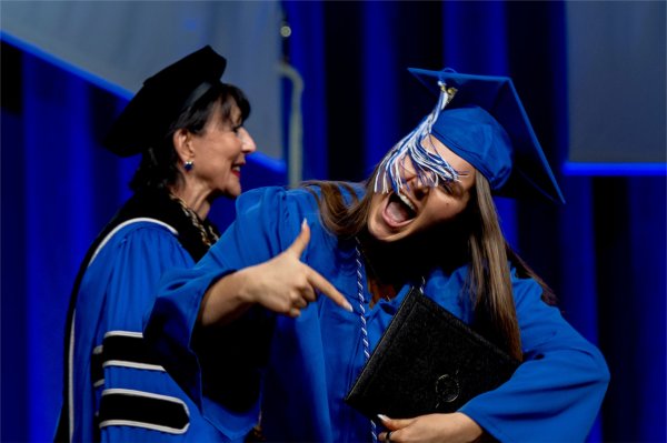 A graduate reacts while walk past the stage after receiving their diploma during the Commencement ceremony at Van Andel Arena on May 2.