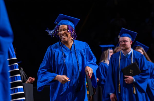 A graduate walks past the stage after receiving their diploma during the afternoon Commencement ceremony at Van Andel Arena on May 2.
