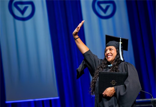 A graduate reacts while walk past the stage after receiving their diploma during the Commencement ceremony at Van Andel Arena on May 1.

