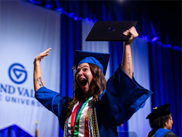  A graduate celebrates after receiving their diploma during the Commencement ceremony at Van Andel Arena Friday, May 1.
