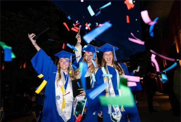 From left to right, Camille Lafluer, Abagail (Bee) Scannel and Katelyn Schuler pose with confetti during Grand Valley State University&#8217;s spring Commencement at Van Andel Arena on May 1, 2026.