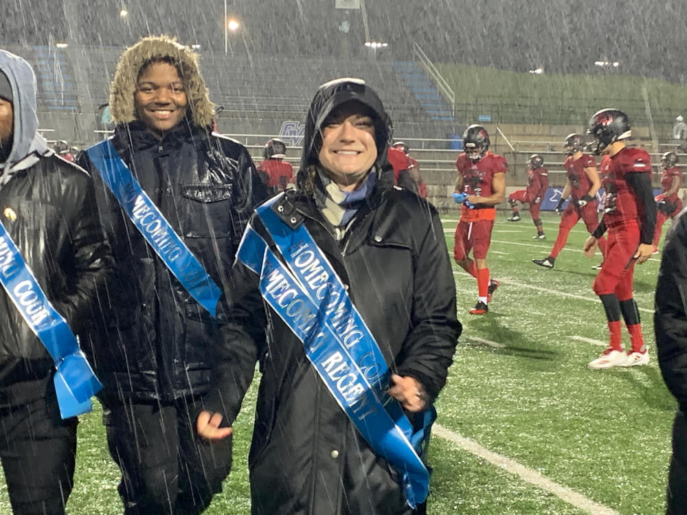 football game, pouring rain