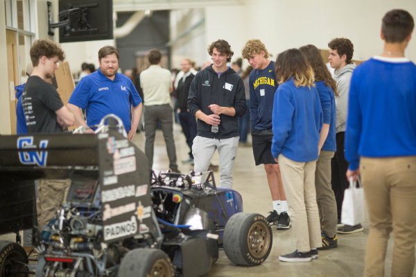 group of students look at the Laker Racing Club car