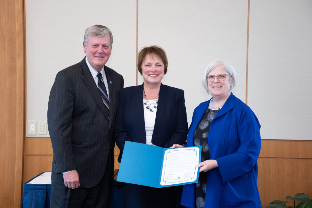 From left: President Thomas J. Haas, Teri Losey, Board chair Mary Kramer