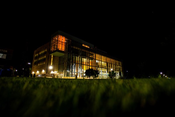 A university library is illuminated at night.