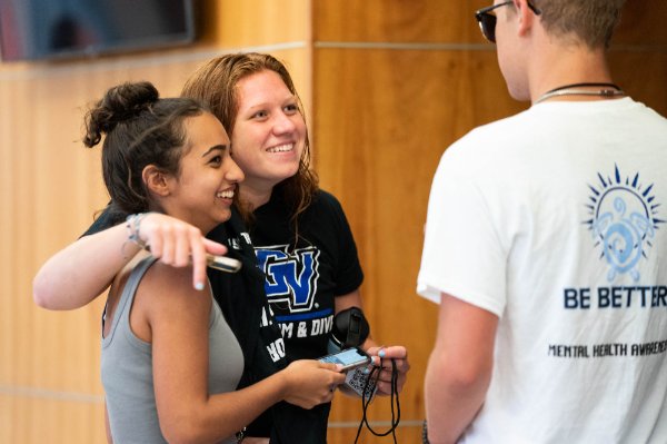 Student athletes hug at SEA of Change keynote address