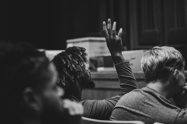 A student raises his hand during the SEA of Change keynote address