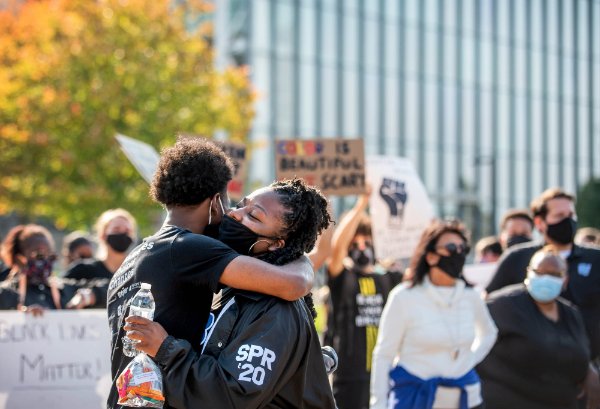 People embrace at the GVSU solidarity march on the Allendale Campus Friday, October 9.