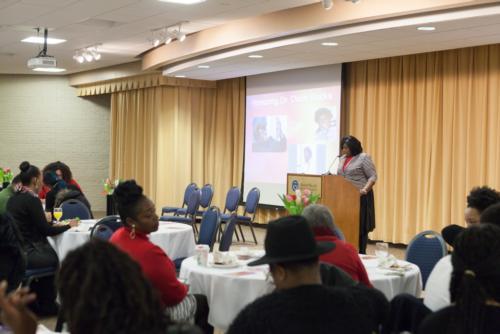 Shawn Jenkins, director of the Muskegon Regional Center, tells the audience about Doris Rucks, recipient of the Trailblazer Award, during a Positive Black Women event.