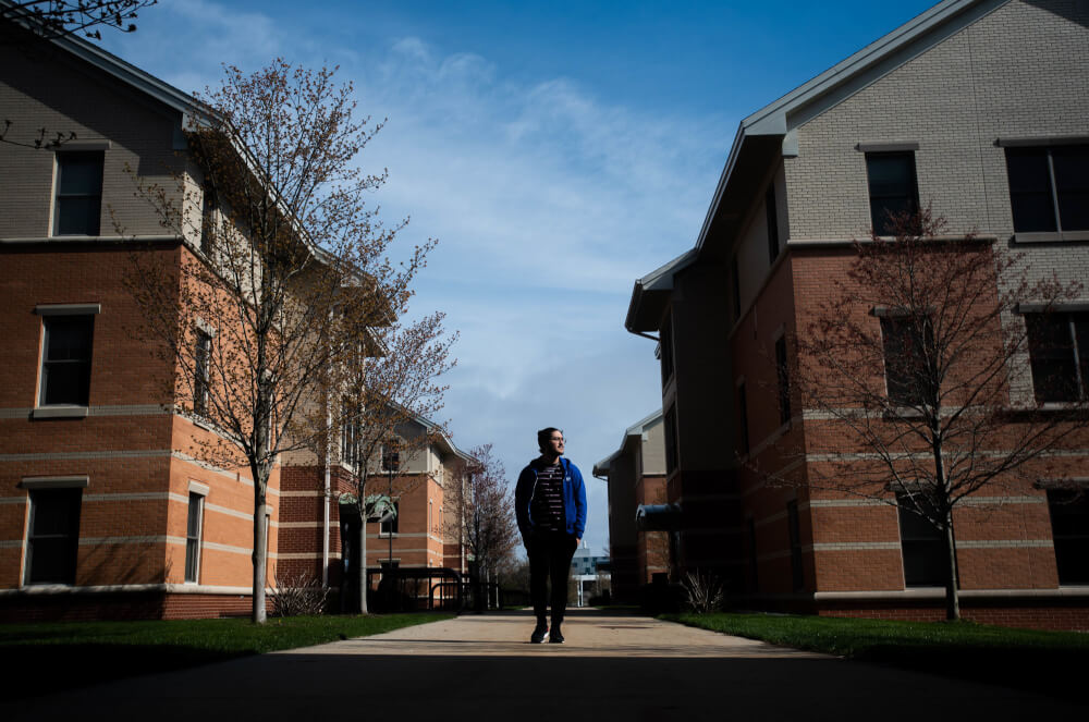 Renzo Garza Motta, a junior international student studying electrical engineering, takes a walk around his dormitory at Murray Living Center on April 28.
