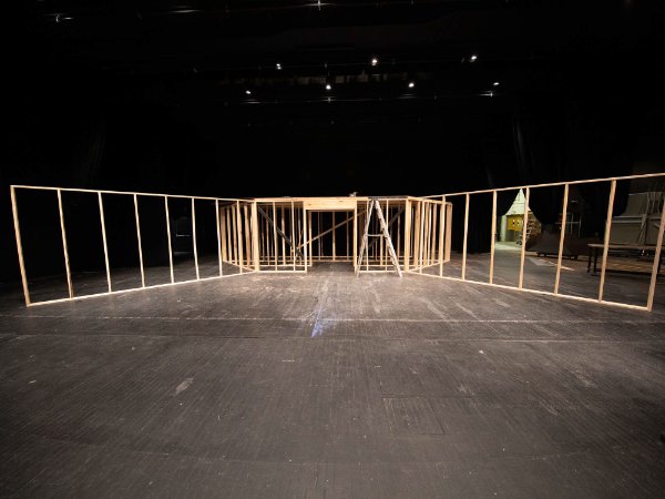 Boards are in place to form the outline of walls as they sit on stage.