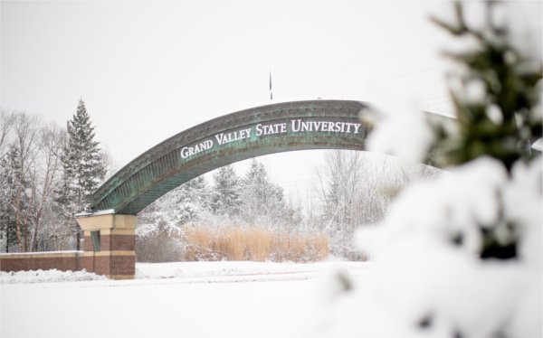  The entrance arch to Grand Valley State University is seen among snow-covered trees. 