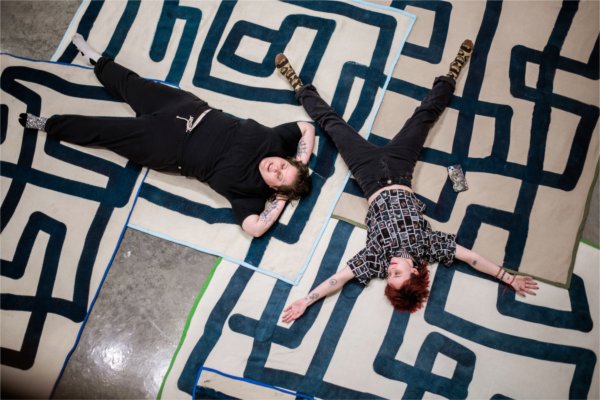  Two college students seen from above make "snow angels" and rest on the art maze blankets during an art exhibition. 