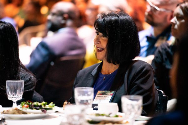 President Philomena V. Mantella listens to a speaker at the 50 Most Influential Women event in Grand Rapids.