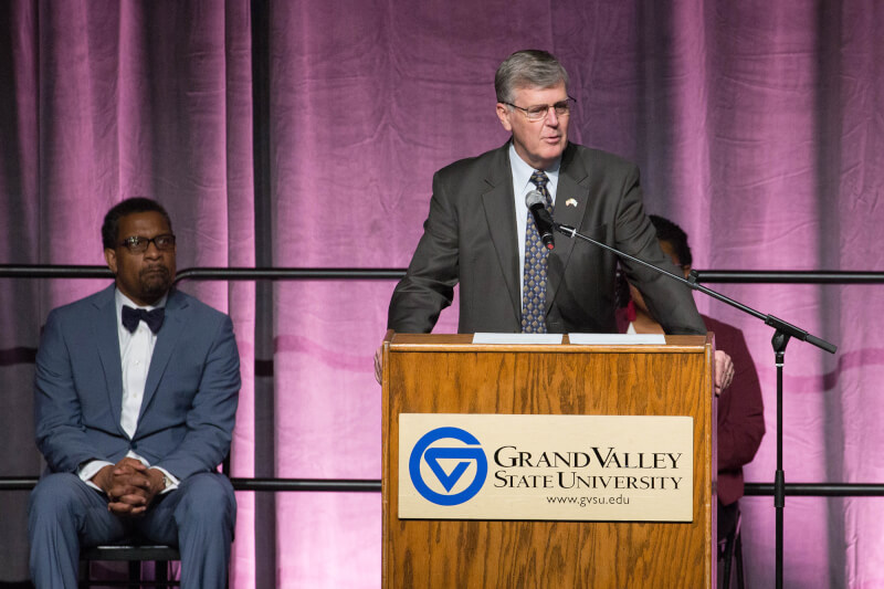 man at podium on stage