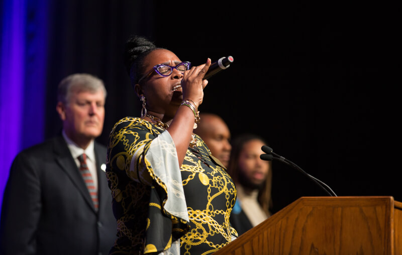 Woman signing into microphone