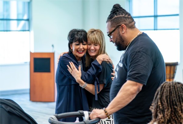 President Philomena V. Mantella, left, hugs Marlene Kowalski-Braun, associate vice president and deputy chief Inclusion and Equity officer, as they look at Remi and Riley, the babies of Robert Shorty, vice president for People, Equity, and Culture, as part of a Juneteenth Celebration at the Kirkhof Center on June 18.